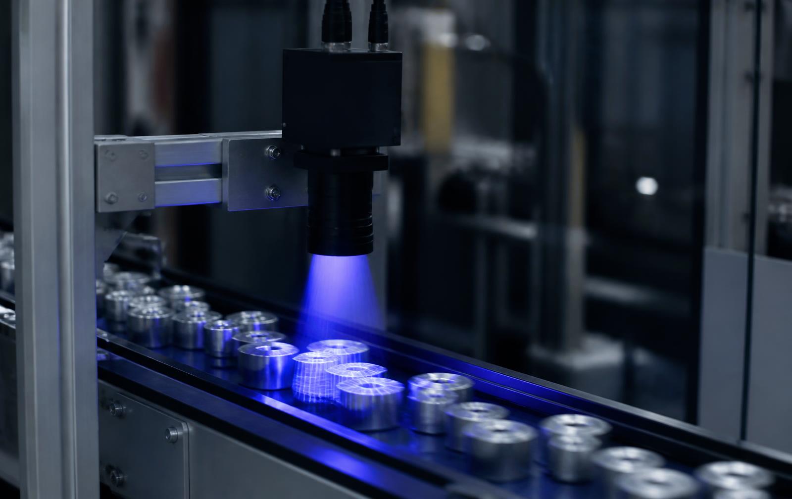 Camera inspecting components moving along a production line
